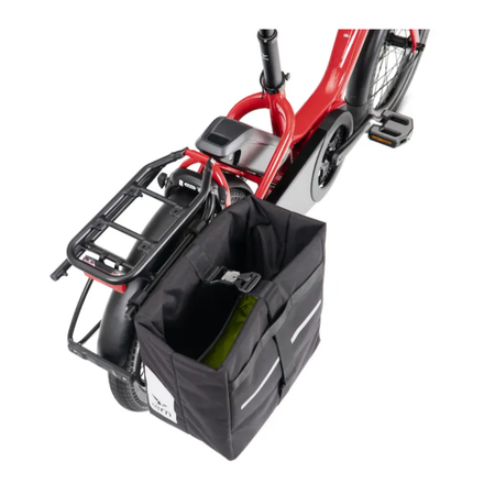 A black Tern Cargo Hold Pannier attached to the rear rack of a red Tern NBD electric bicycle, shown against a plain white background.