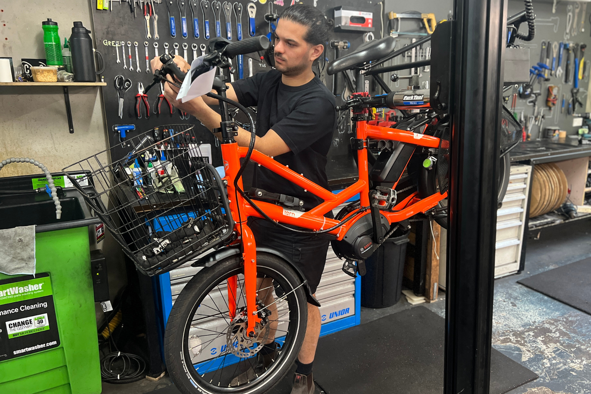 An electric bike mechanic working on an electric bike in an electric bike workshop.