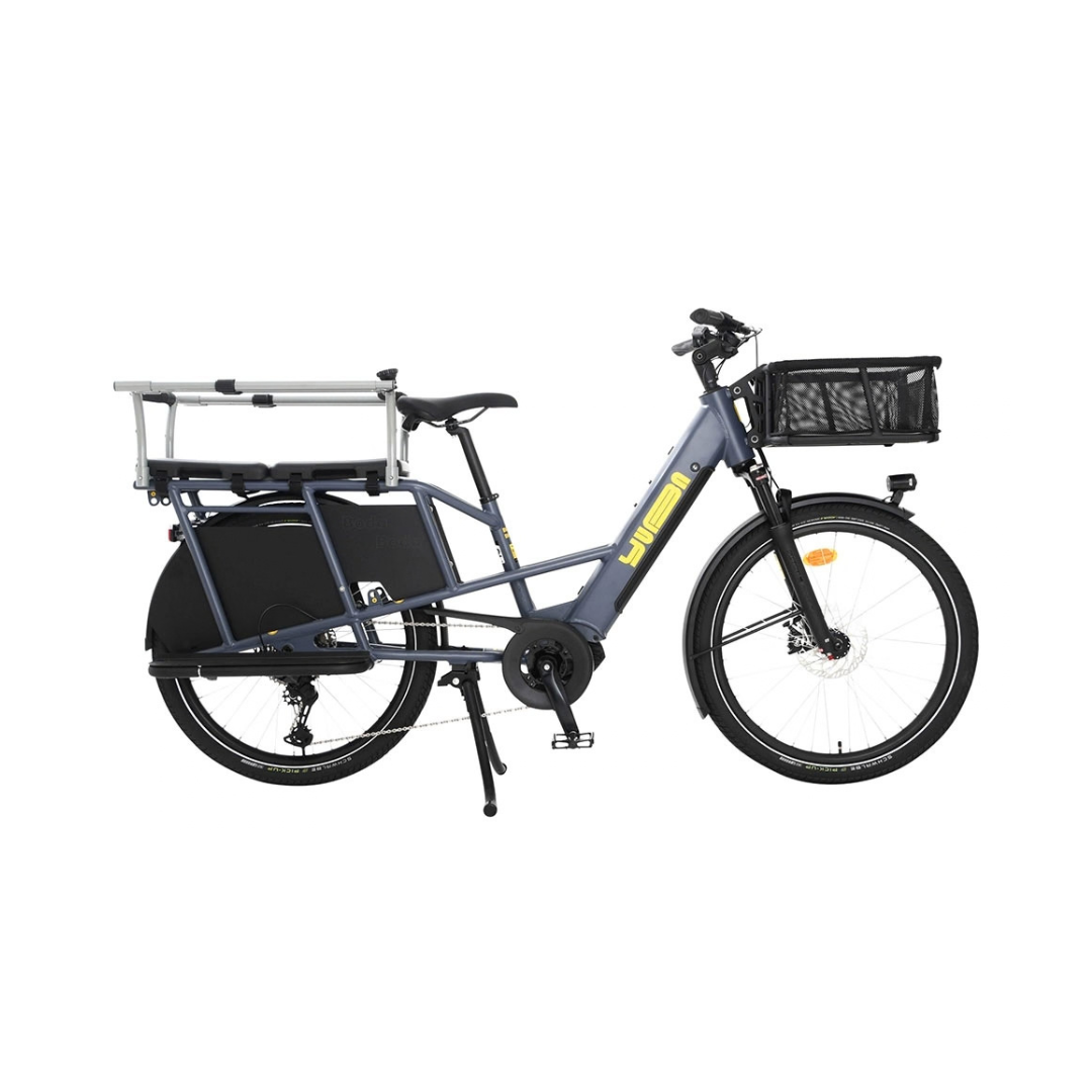 A dark gray Yuba electric cargo bike with a black rear cargo box, a front basket, and a silver step-through rack, shown against a plain white background.